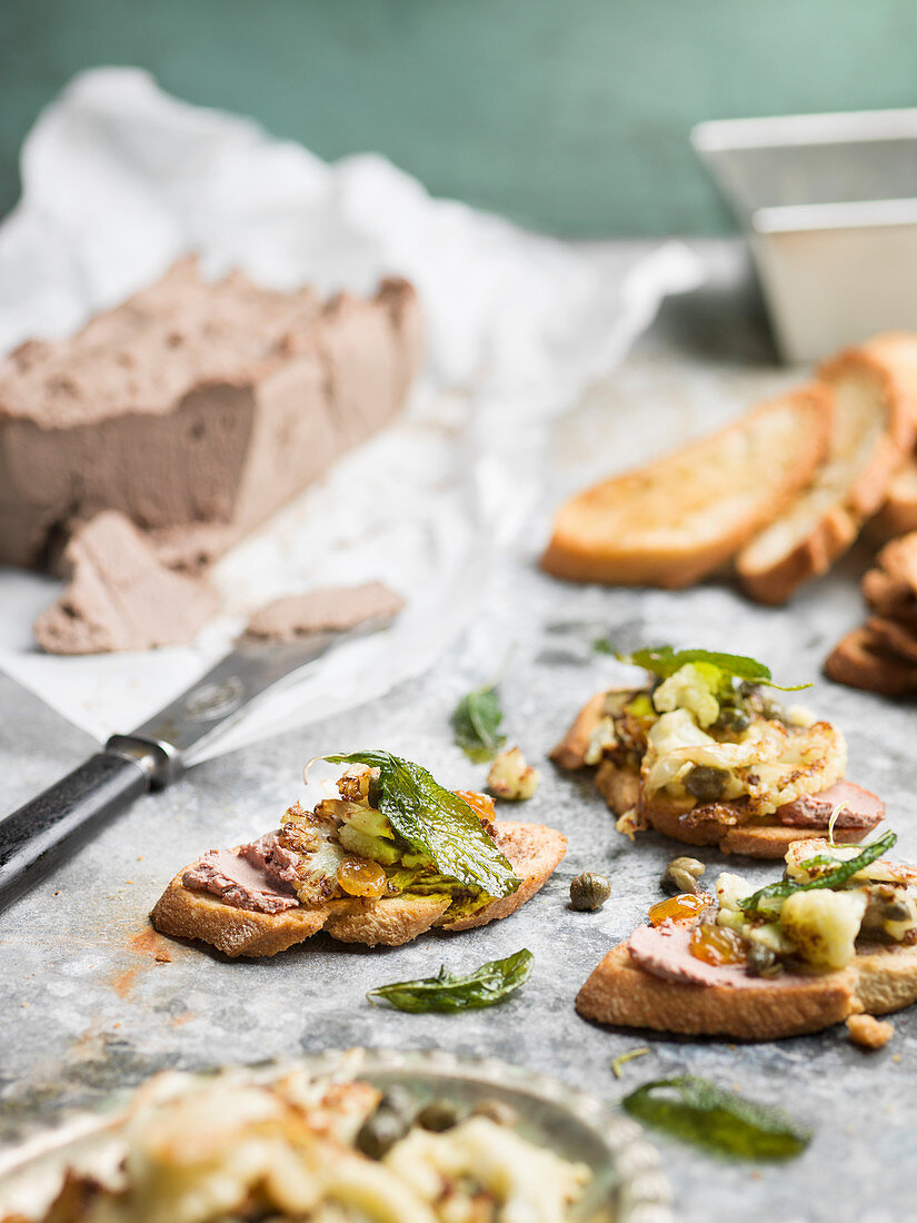 Toasted bread with liver pate, cauliflower and capers