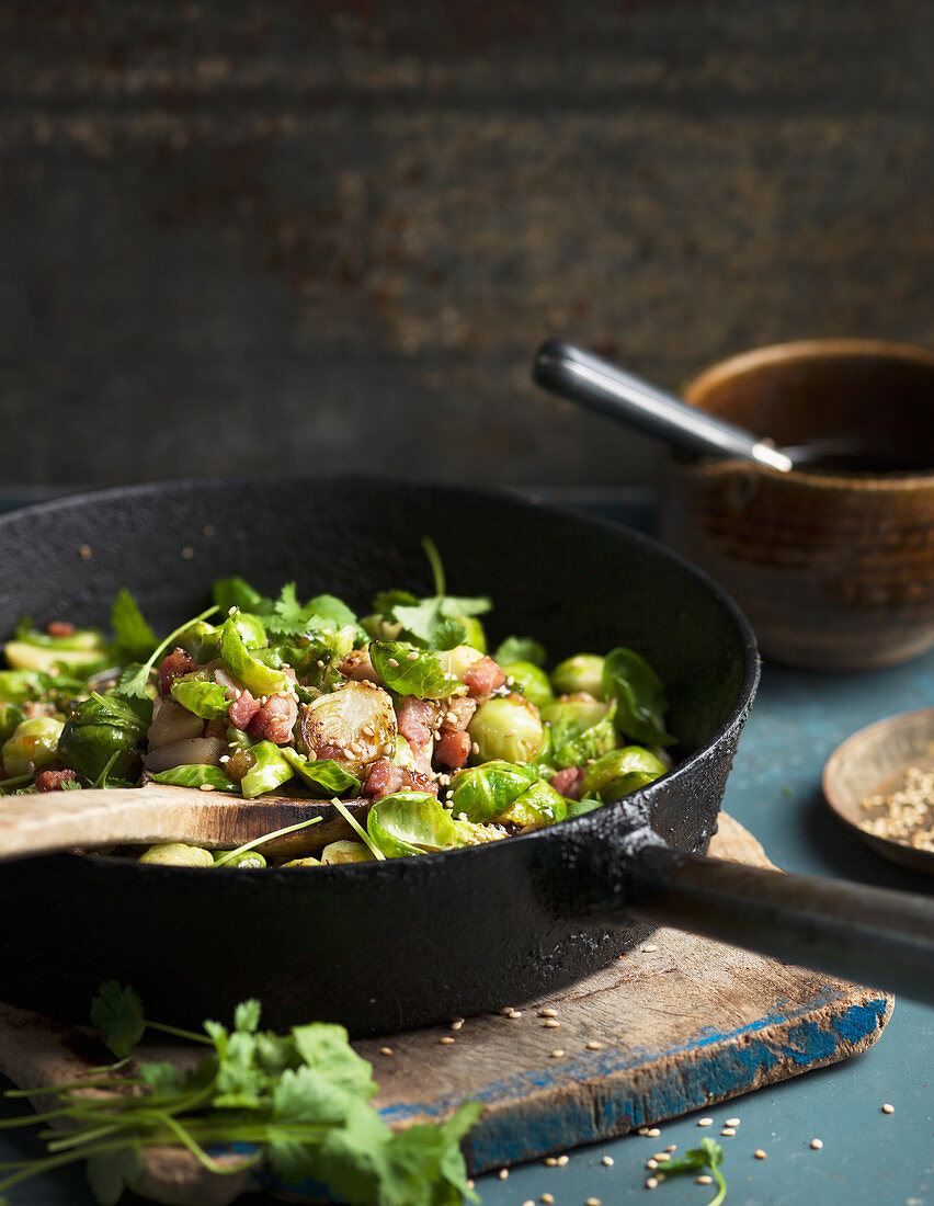 Brussels sprouts with bacon on frying pan