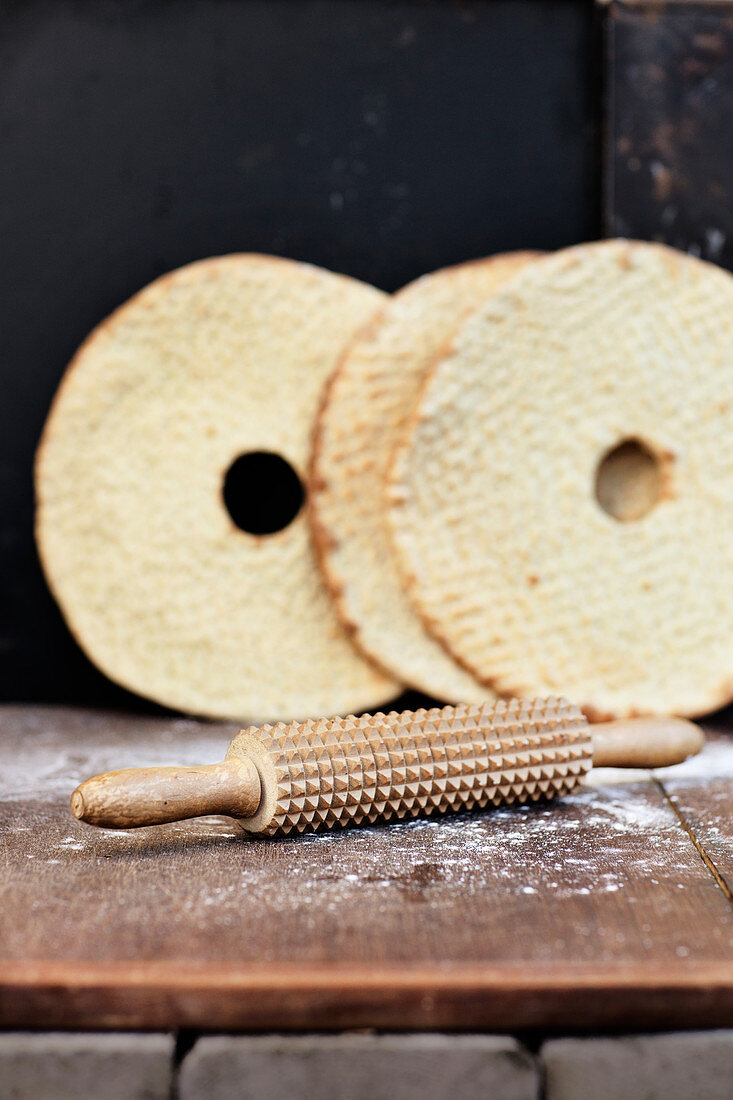 Rolling pin with flatbread on background