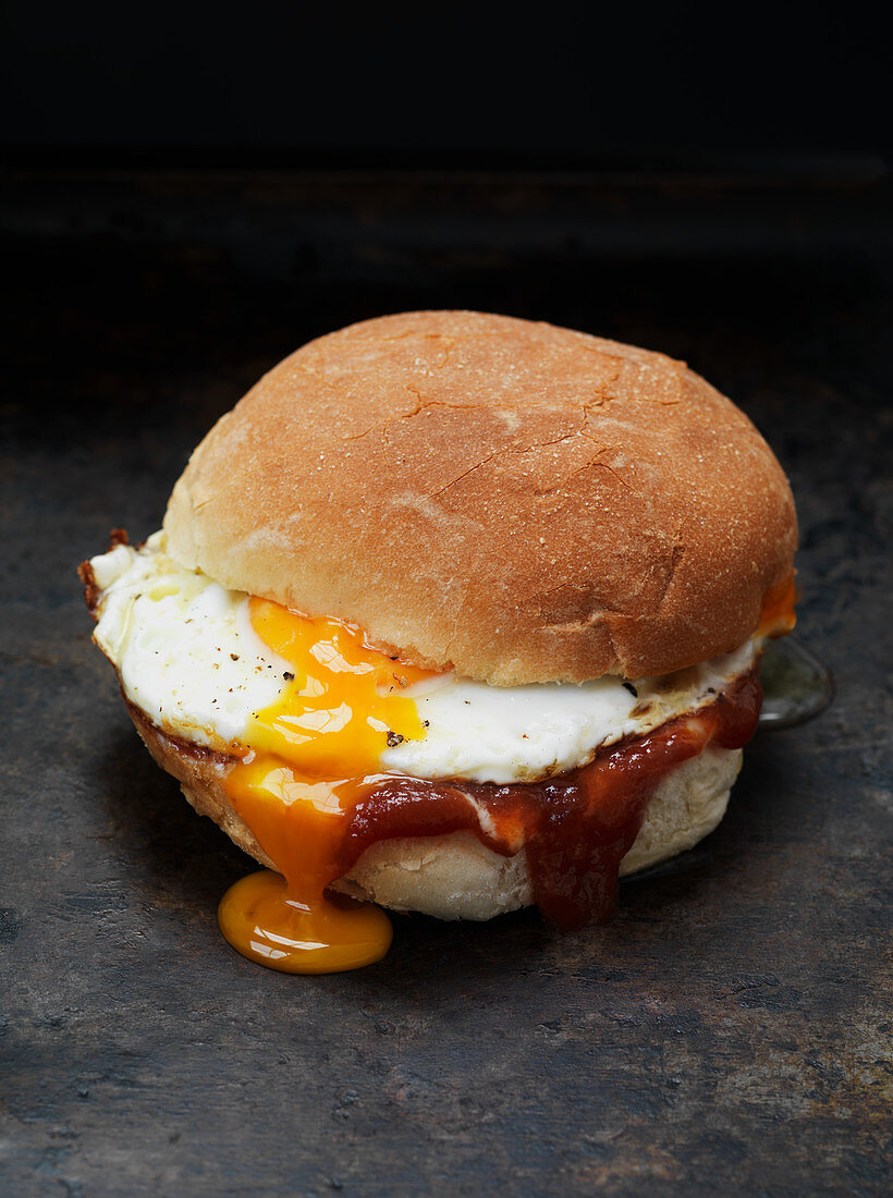 A sandwich with bacon and fried egg