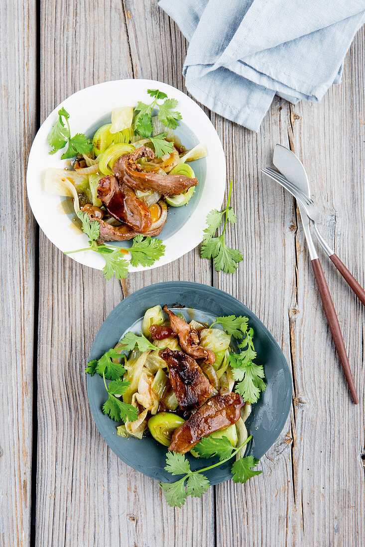 Fried duck with pointed cabbage and leek