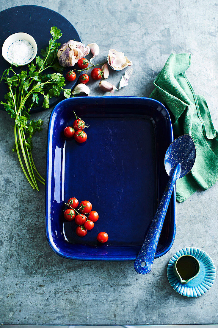 A blue baking dish with cherry tomatoes