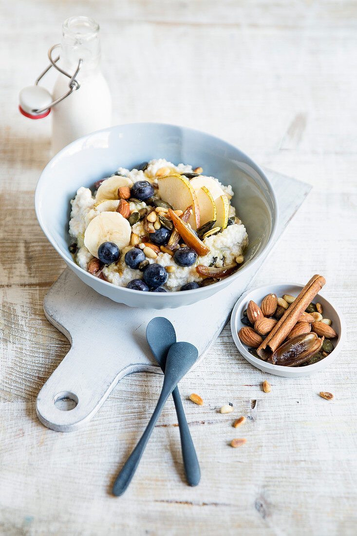 Warm millet and pear muesli with dates and an almond drink