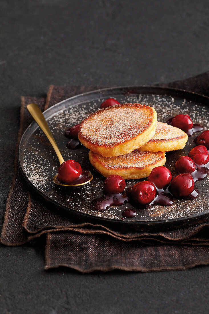Fried yeast cakes with preserved cherries