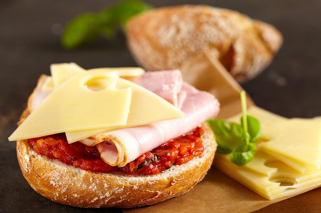 A sandwich with homemade tomato relish, ham and Emmental