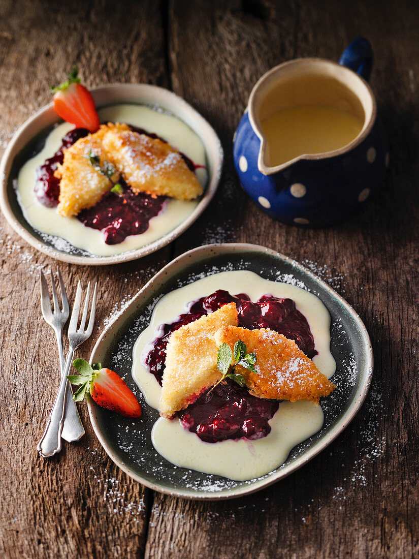 Semolina slices with red berry jelly and vanilla sauce