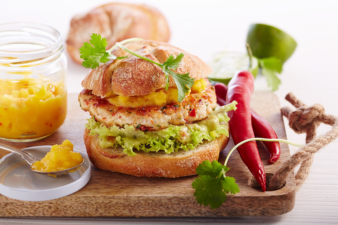 Chicken burger with guacamole, chillies and mango salsa