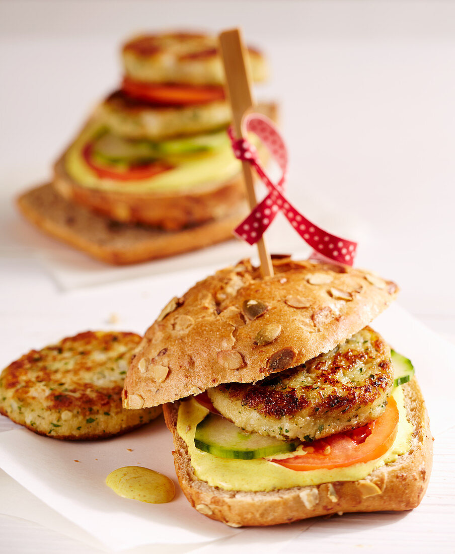 Vegetarian cauliflower burgers made with potatoes, breadcrumbs with curry mayonnaise, and yoghurt on a wholemeal roll