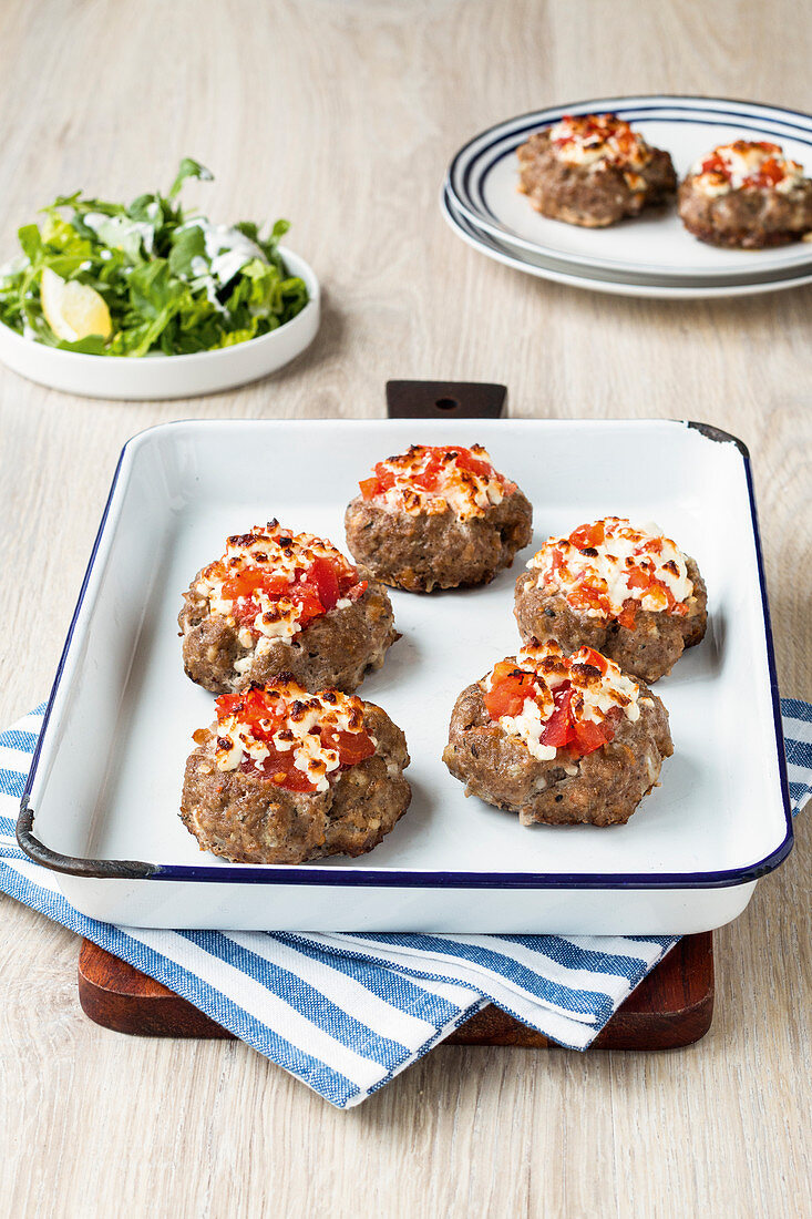 Minced meat nests filled with a tomato and sheep's cheese topping