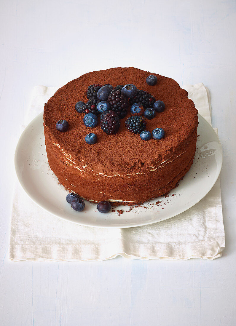 A layered tiramisu cake with blueberries