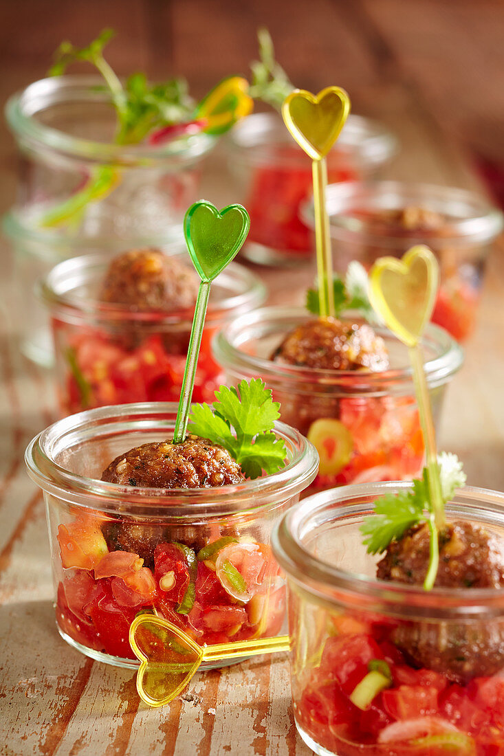 Summer party snack: fried meatballs with tomato salsa in mason jars