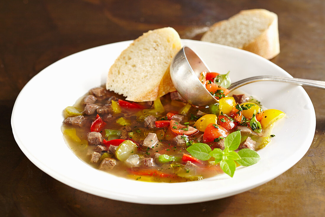 Roast beef stock with cherry tomato vinaigrette and white bread