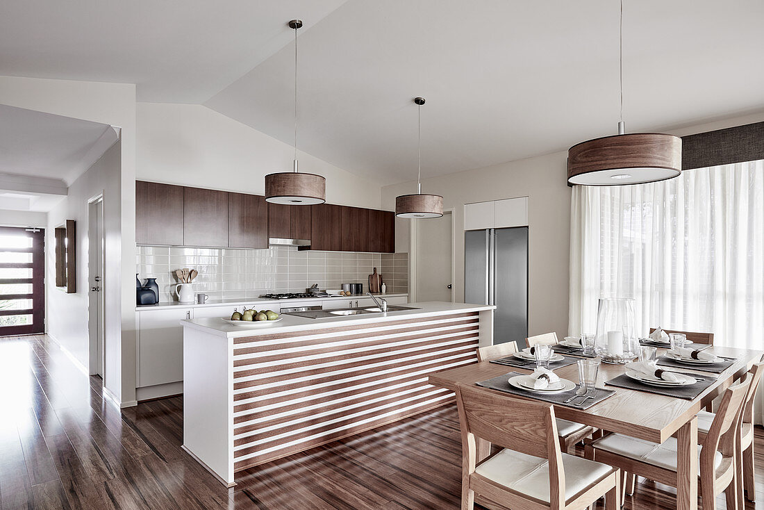 Dining area and kitchen island in open-plan interior