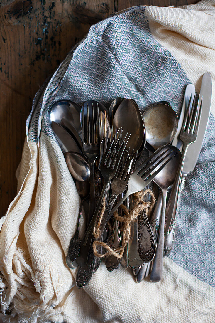 Vintage cutlery on tea towel