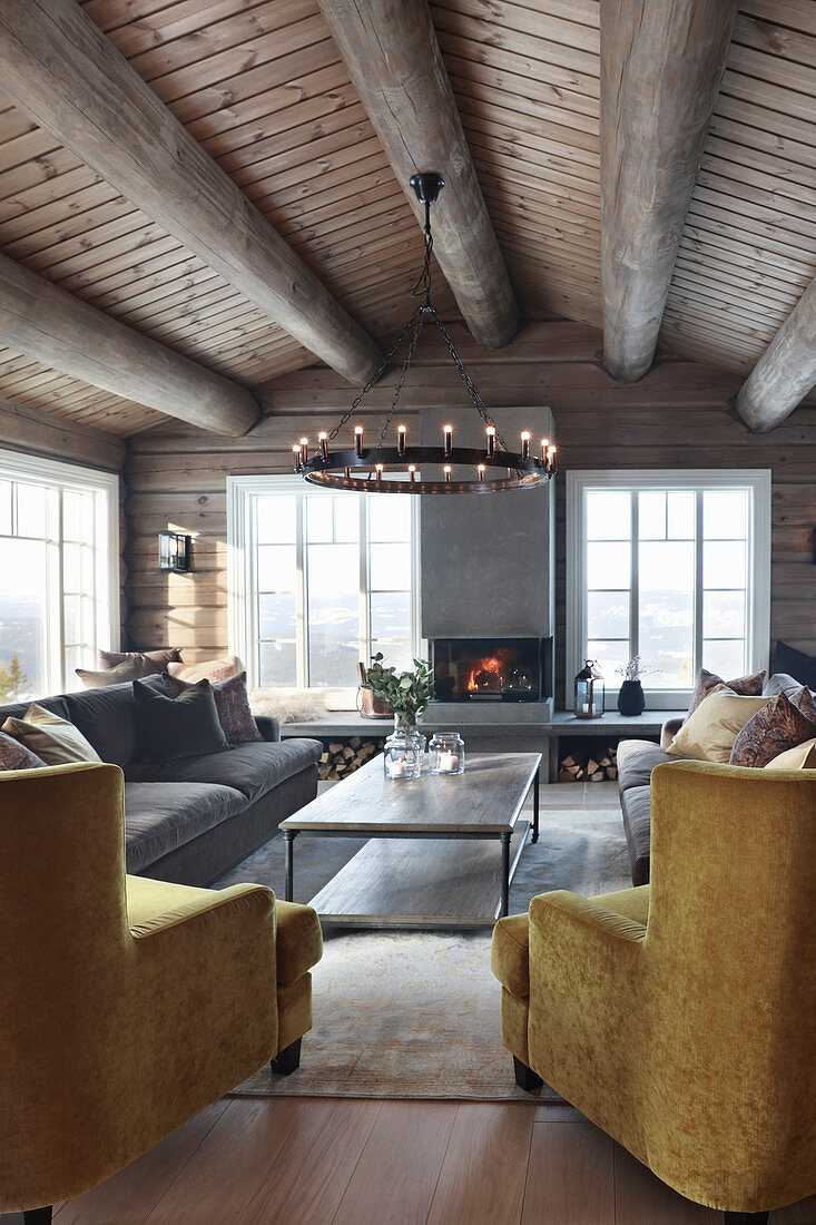 Open fireplace in living room of modern log cabin