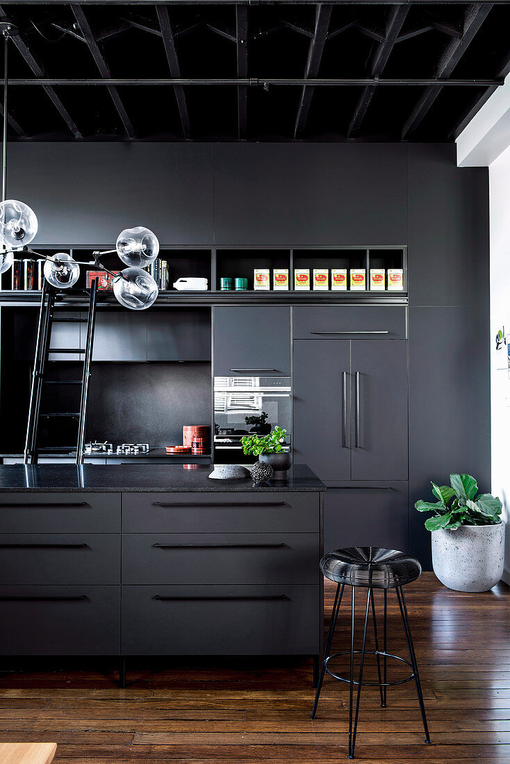 Modern black kitchen with kitchen island and built-in cupboards