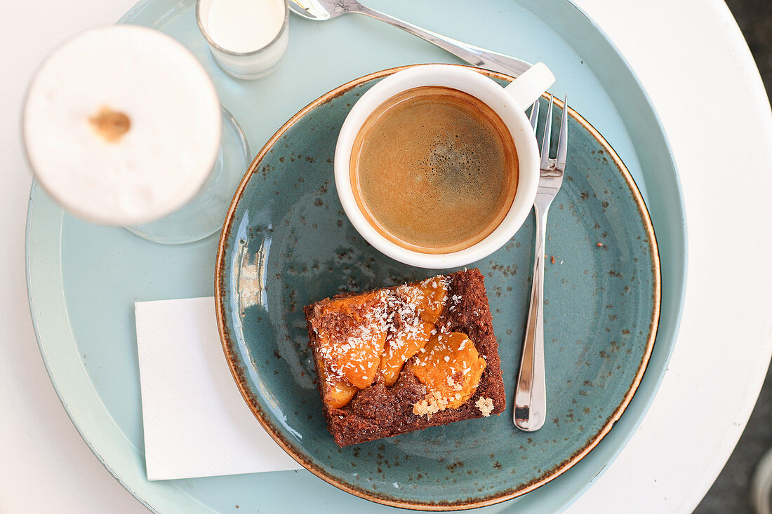 Cafe lungo with a slice of apricot cake