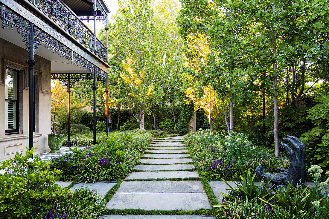 Path of large flagstones through summer garden