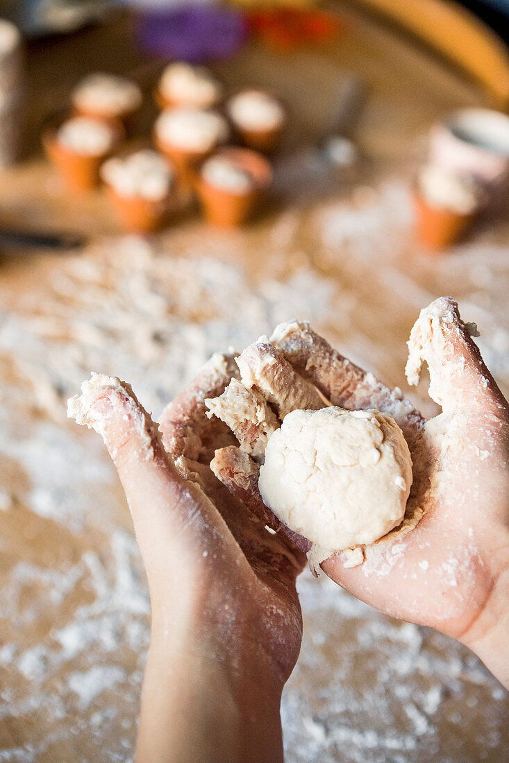 Childs hands holding dough