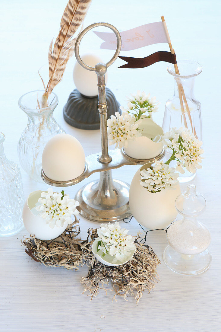 Egg shells on wire bases used as vases for tiny white flowers