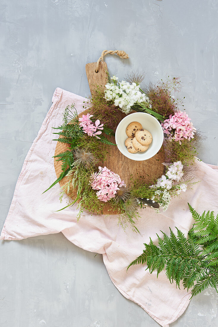 Wreath of flowers and seed heads decorating table