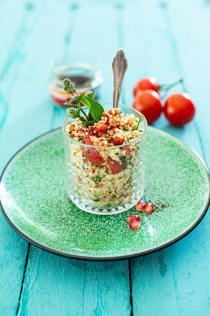 Couscous salad with pomegranate, mint, sumac and tomatoes