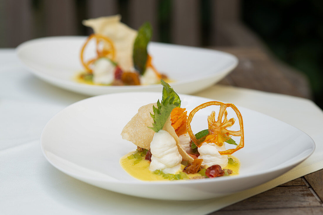 Yellow tomato and pepper cream with goat's cheese mousse