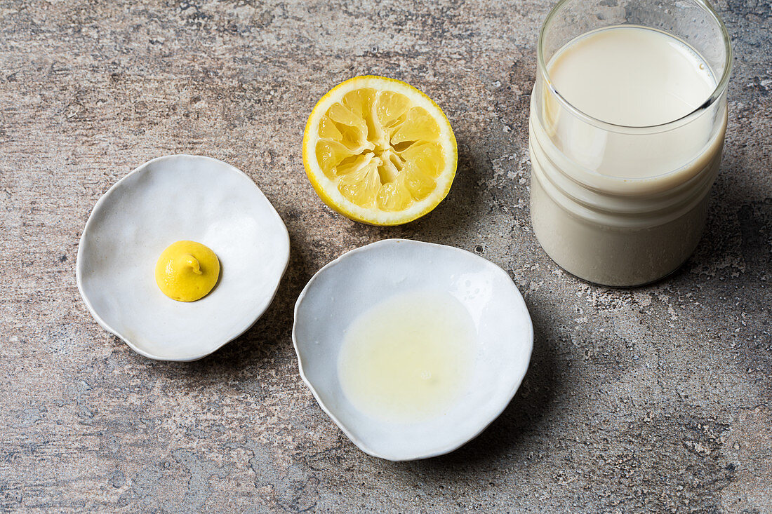 Ingredients for egg-less mayonnaise – soya drink, mustard, lemon juice