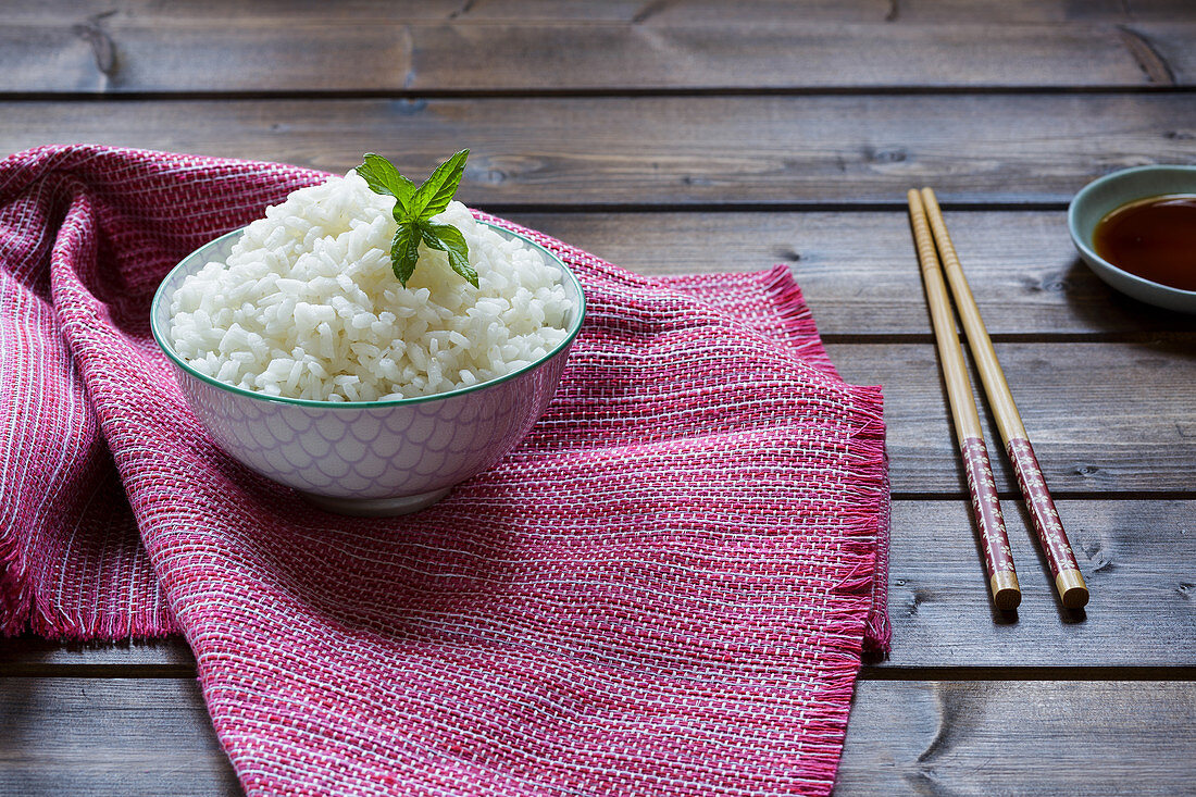 Boiled basmati rice in a bowl with chopsticks