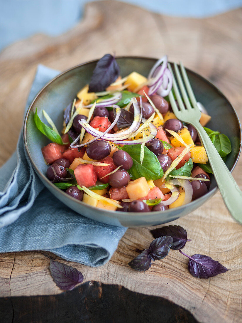 Süß-saurer Obst-Oliven-Salat mit Basilikum und Zwiebel