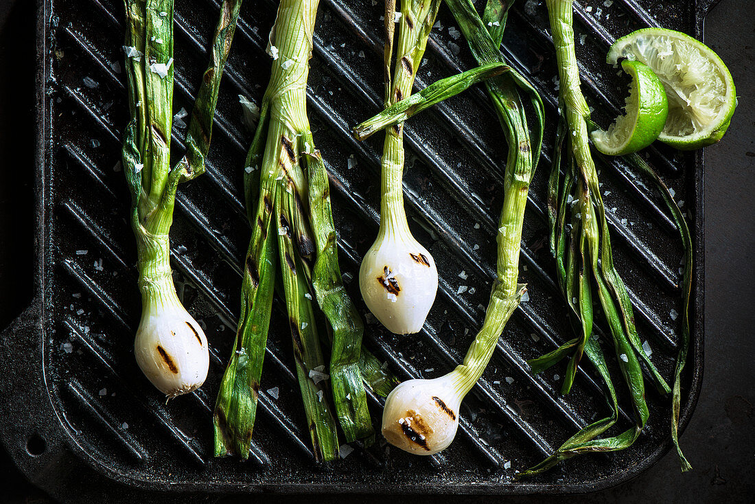 Cebollitas (grilled green onion bulbs) on csat iron griddle with squeezed lime