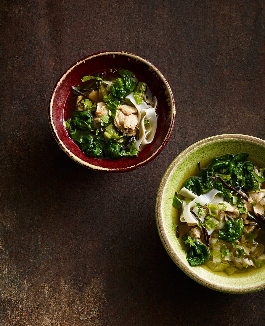 Oriental chicken soup with black chanterelle mushrooms, spinach and sugar loaf chicory