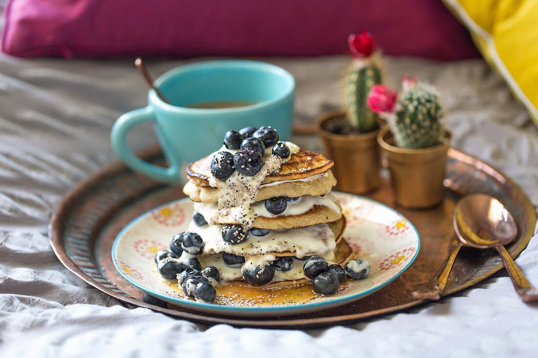 Gluten free banana pancakes with blueberries and soy yoghurt