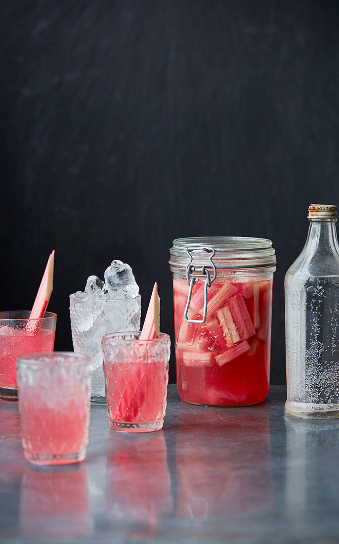Rhubarb gin served in a glass jar and in glasses