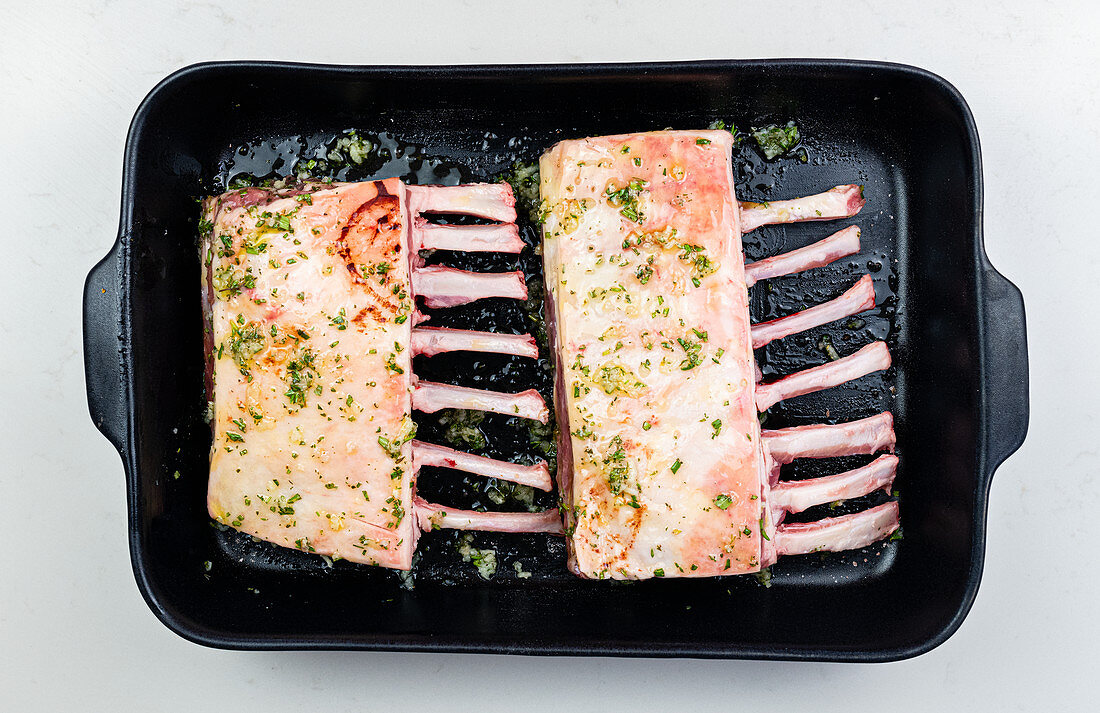 Raw rack of lamb in a roasting tray