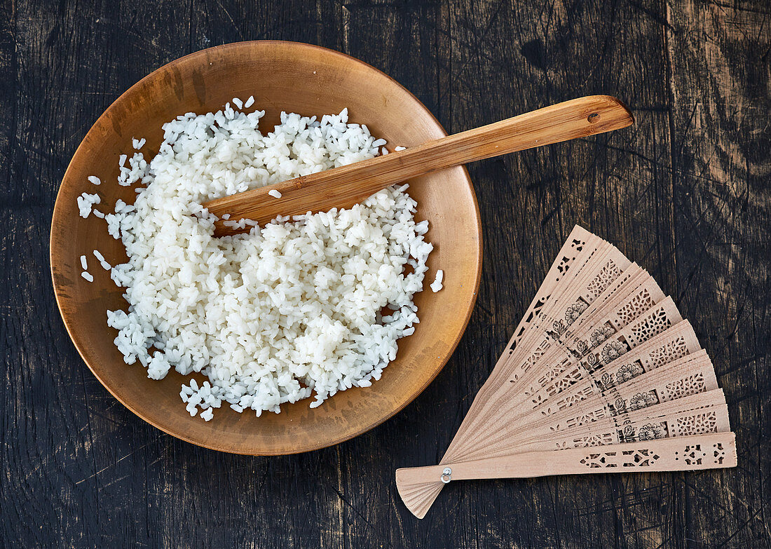 Cooked sushi rice in a wooden bowl