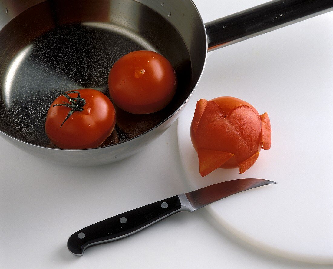 Placing tomatoes briefly in boiling water before peeling