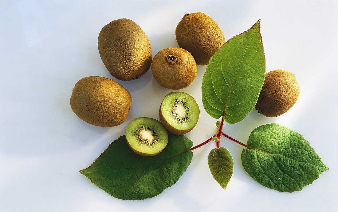 Five whole and one half kiwi fruit; leaves