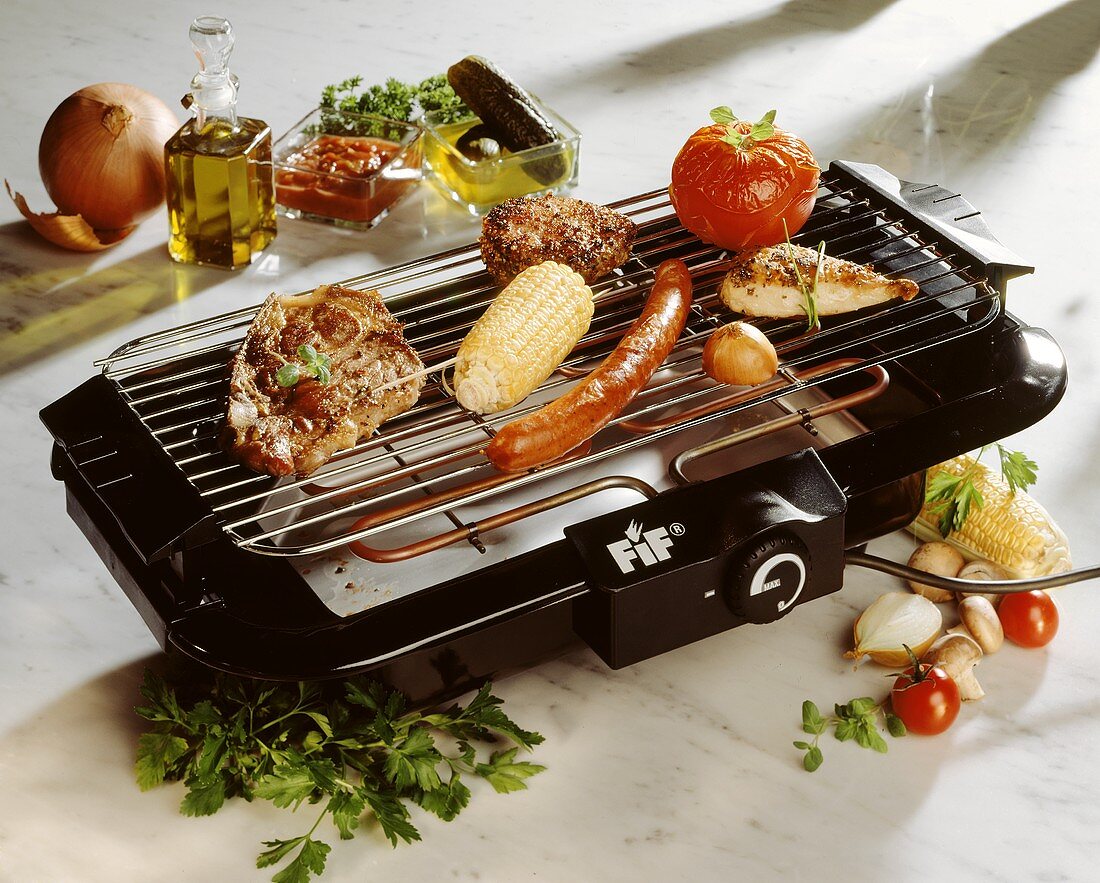Assorted Meats and Vegetables on an Electric Grill