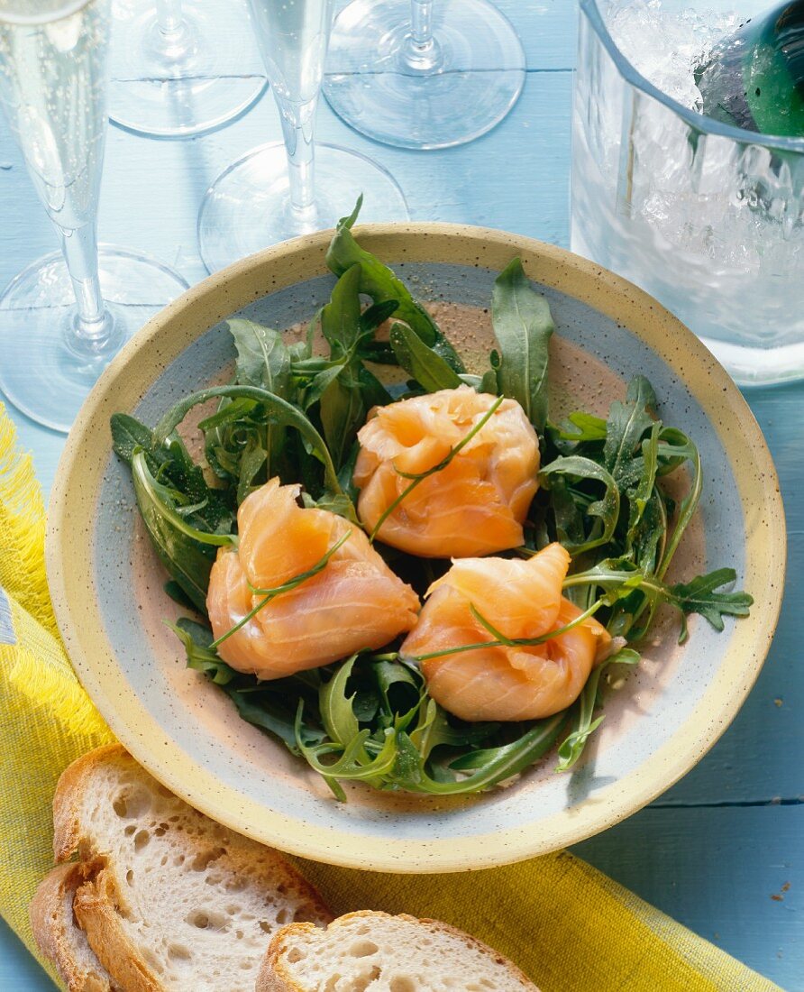 Filled salmon parcels on rocket salad