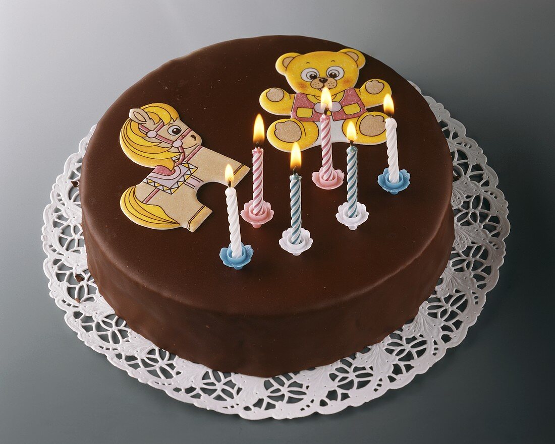 Chocolate cake for child's birthday, with candles & pictures