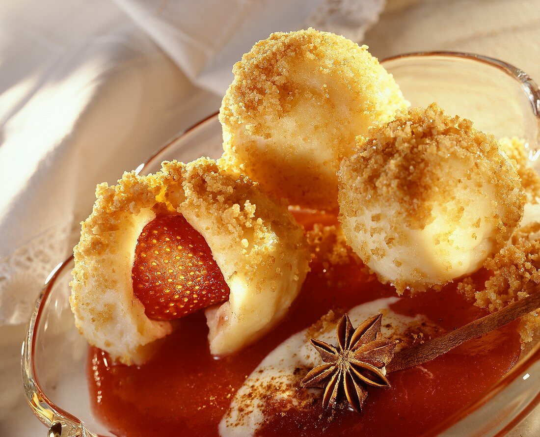 Strawberry dumplings with buttered breadcrumbs on strawberry sauce