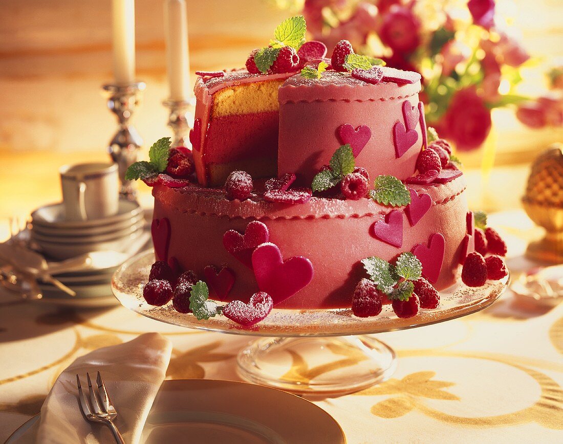 Two-tier raspberry gateau decorated with marzipan hearts