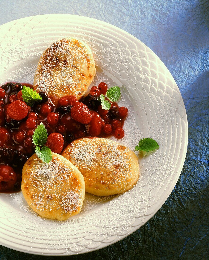 Quark griddle cake with stewed berries on dessert plate