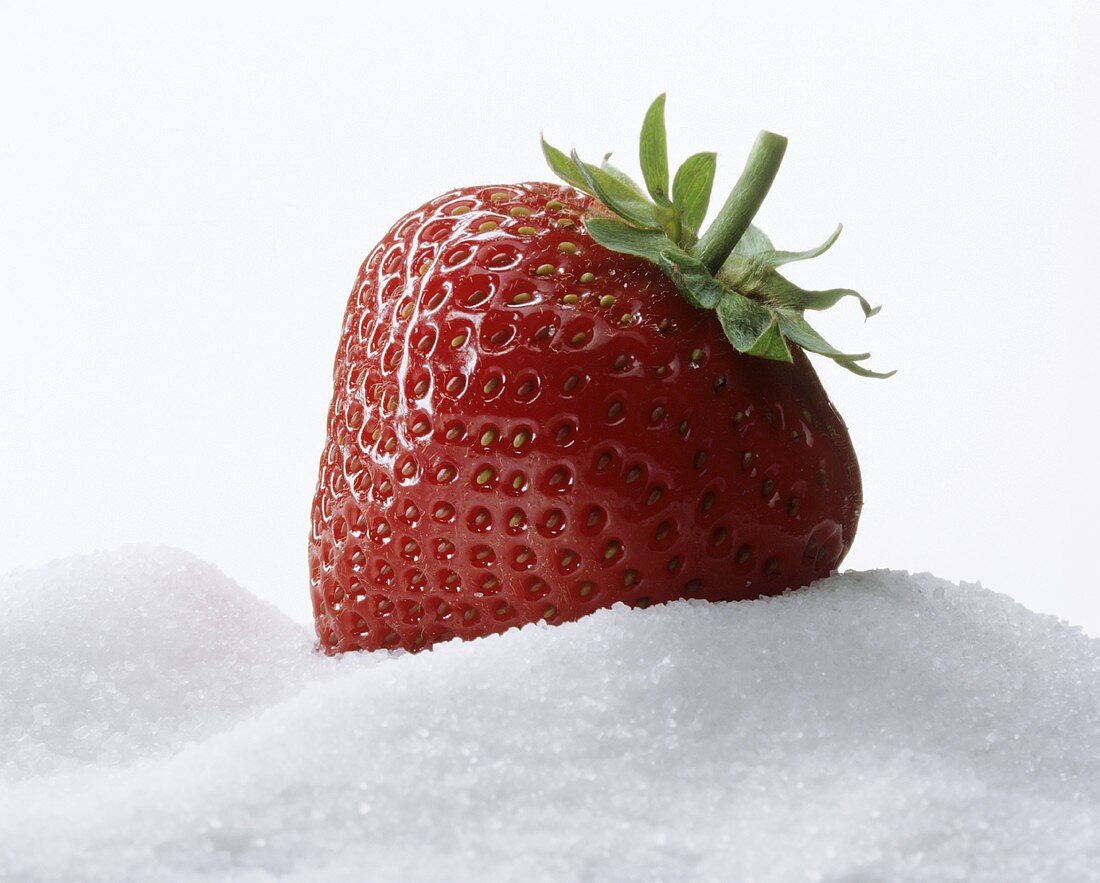 Strawberry lying on sugar