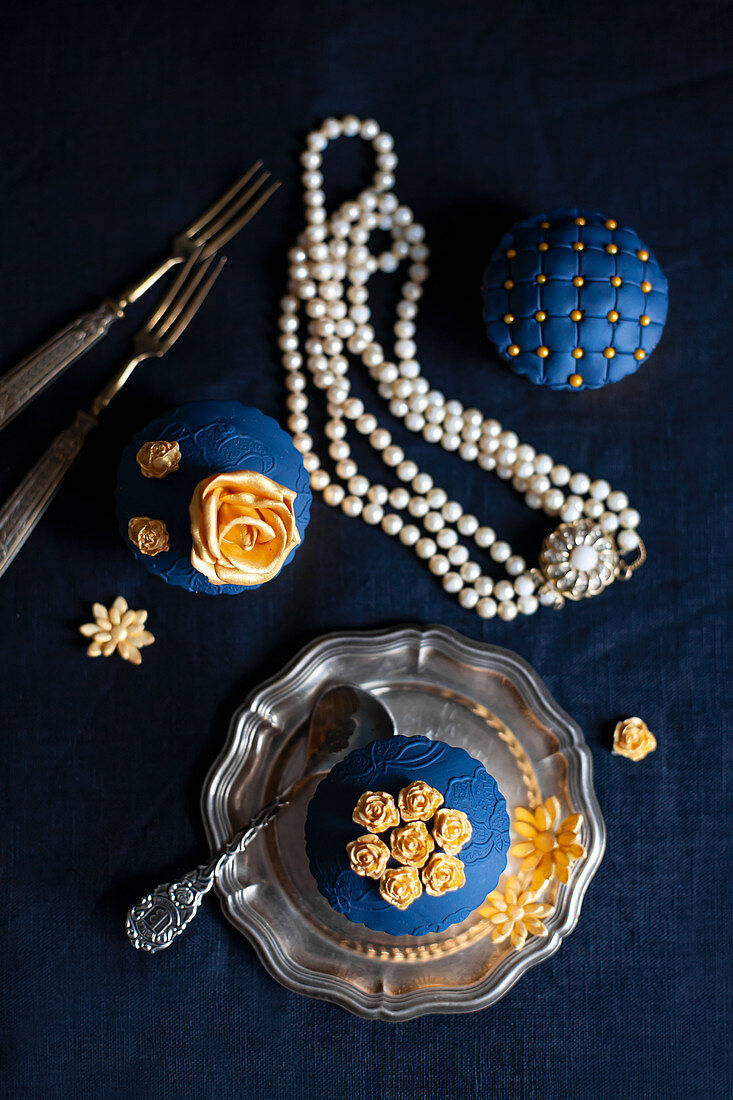 Perfectly decorated cupcakes with blue and gold toppings