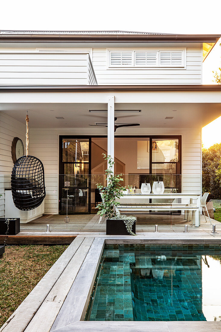 Swimming pool in garden outside American-style house