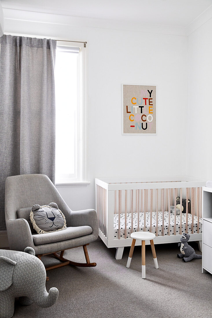 Rocking chair and cot in modern nursery decorated in grey