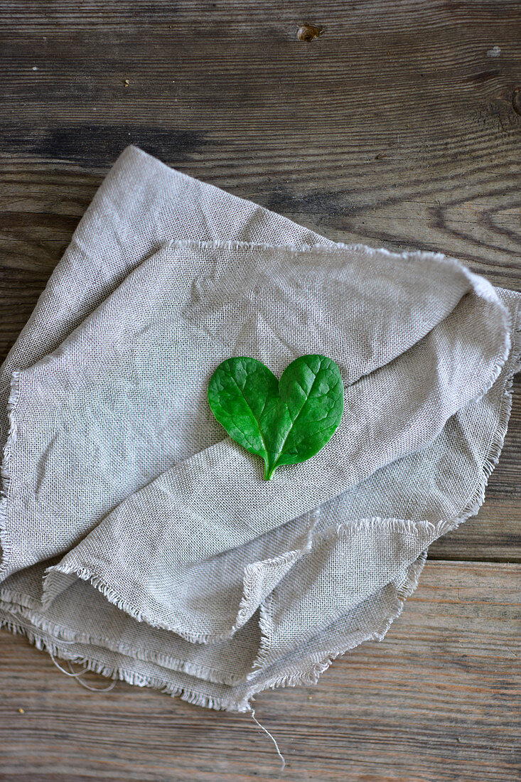 A spinach-leaf heart on a cloth