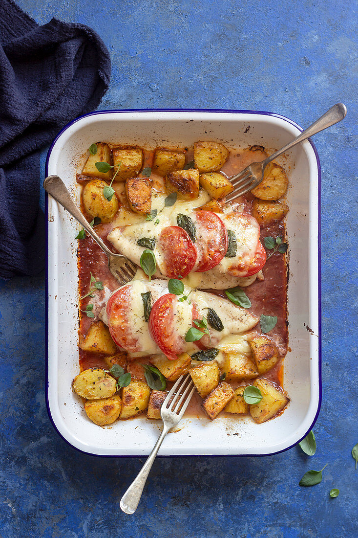 Caprese chicken - chicken breasts baked in tomato sauce with tomatoes, mozzarella, basil and baked potatoes